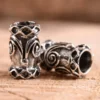 Bartperle und Lockenperle mit Spirale und Rauten aus Silber